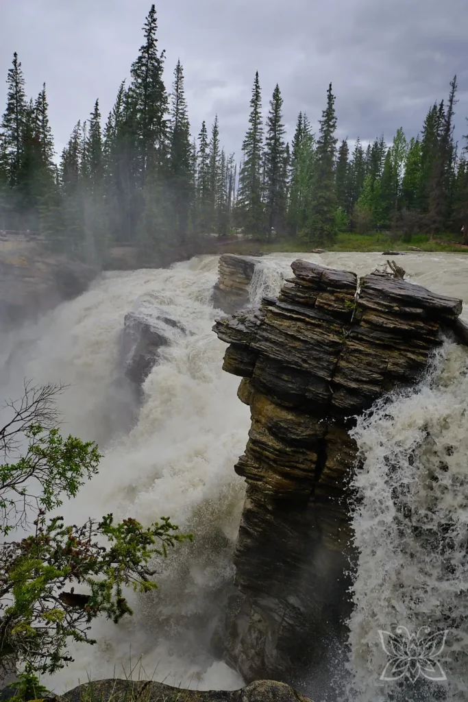 Wasserfall mit Felstrukturen im Vordergrund